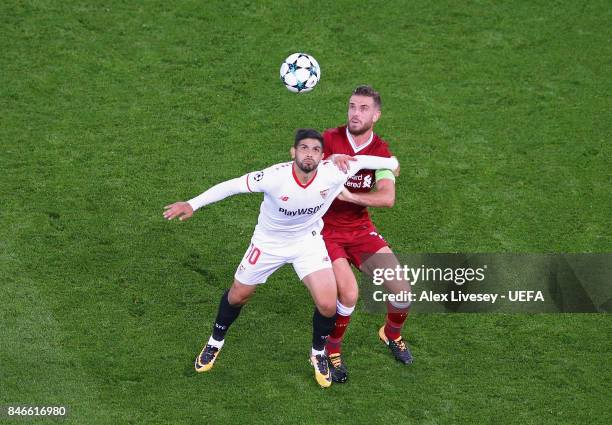 Ever Banega of Sevilla FC shields the ball from Jordan Henderson of Liverpool FC during the UEFA Champions League group E match between Liverpool FC...