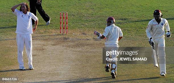 West Indies cricketer Ramnaresh Sarwan and captain Chris Gayle take a run as England's bowler Ryan Sidebottom reacts during the second day of the...