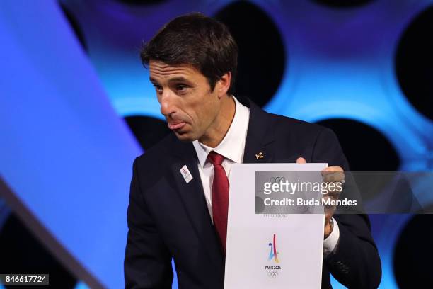 Paris 2024 Bid Co-Chair and 3-time Olympic Champion Tony Estanguet shows and IOC document during a joint press conference between IOC, Paris 2024 and...