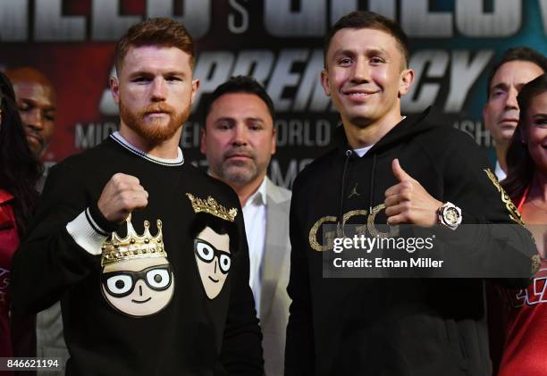 Golden Boy Promotions Chairman and CEO Oscar De La Hoya looks on as Canelo Alvarez and WBC, WBA and IBF middleweight champion Gennady Golovkin pose...