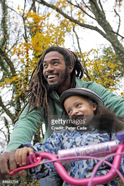 fater and daughter with childs bike - braiding hair stock pictures, royalty-free photos & images