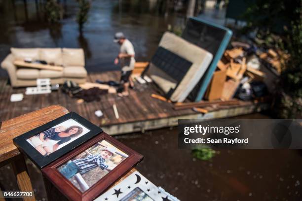 People clean up as floodwaters from the Hurricane Irma recede September 13, 2017 in Middleburg, Florida. Floodwaters in town from the Black Creek...