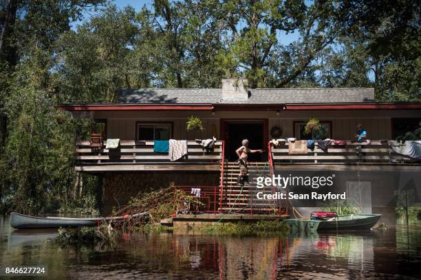 Homeowner Mike Riley power washes his front steps as floodwaters from Hurricane Irma recede September 13, 2017 in Middleburg, Florida. Flooding in...