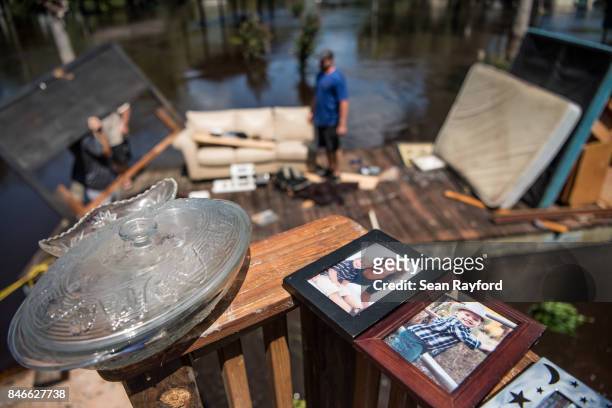 People clean up as floodwaters from the Hurricane Irma recede September 13, 2017 in Middleburg, Florida. Flooding in town from the Black Creek topped...