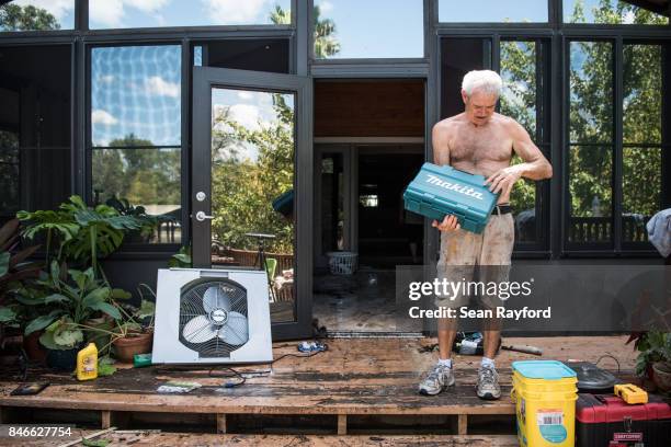 Homeowner James Wade checks for water damaged items as floodwaters from Hurricane Irma recede September 13, 2017 in Middleburg, Florida. Flooding in...