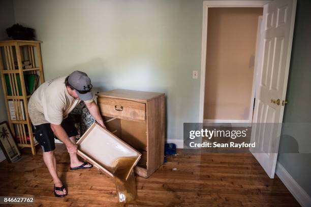 Chris Wisor lends a hand cleaning up as floodwaters from Hurricane Irma recede September 13, 2017 in Middleburg, Florida. Flooding in town from the...