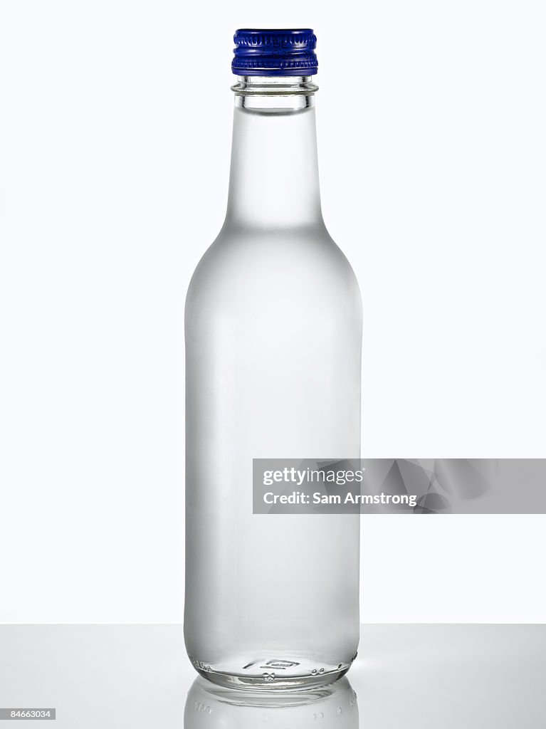 Glass bottle of water.
