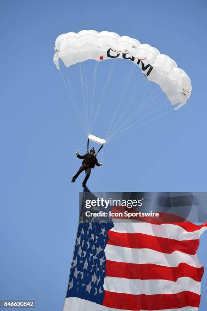 Skydiver parachutes the American Flag into the stadium during a college football game between the Hawai'i Rainbow Warriors and the UCLA Bruins on...