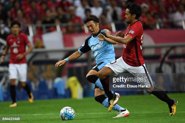 Shinzo Koroki of Urawa Red Diamonds and Yusuke Tasaka of Kawasaki Frontale compete for the ball during the AFC Champions League quarter final second...