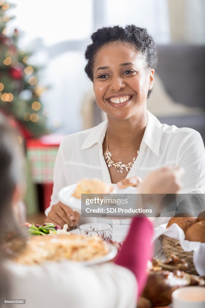 Cheerful Christmas dinner guest receives slice of pie