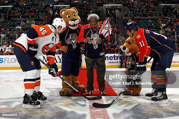 Boxing promoter Don King drops the puck during the ceremonial puck drop before the game between Nate Thompson of the New York Islanders and Gregory...