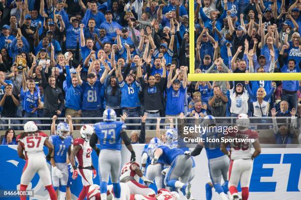 Detroit Lions fans cheer from the end zone seats after Detroit Lions running back Dwayne Washington scores a touchdown during game action between the...