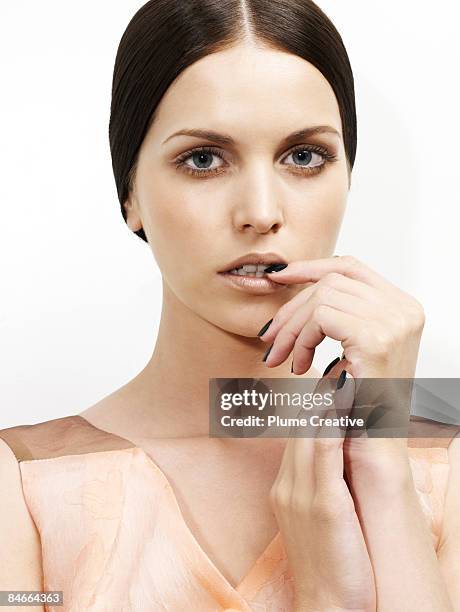 beauty face biting on nail - nail biting stock pictures, royalty-free photos & images