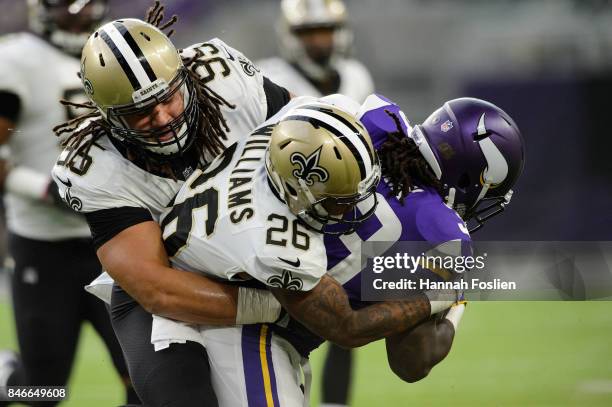 Tyeler Davison and P.J. Williams of the New Orleans Saints tackles Dalvin Cook of the Minnesota Vikings during the game on September 11, 2017 at U.S....