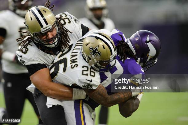 Tyeler Davison and P.J. Williams of the New Orleans Saints tackles Dalvin Cook of the Minnesota Vikings during the game on September 11, 2017 at U.S....