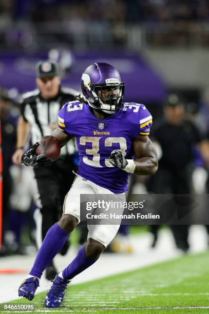 Dalvin Cook of the Minnesota Vikings carries the ball against the New Orleans Saints during the game on September 11, 2017 at U.S. Bank Stadium in...