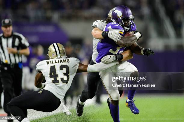 Marcus Williams and A.J. Klein of the New Orleans Saints tackle Dalvin Cook of the Minnesota Vikings during the game on September 11, 2017 at U.S....