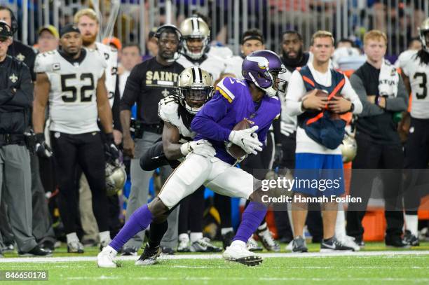 De'Vante Harris of the New Orleans Saints tackles Laquon Treadwell of the Minnesota Vikings during the game on September 11, 2017 at U.S. Bank...