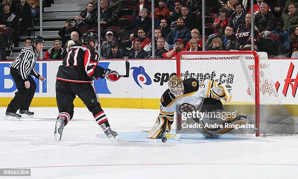 Tim Thomas of the Boston Bruins makes a save against Daniel Alfredsson of the Ottawa Senators on a shoot out attempt at Scotiabank Place on February...