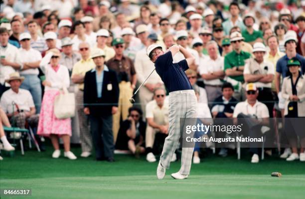 Tom Kite blasts off the tee box in front of a large gallery during the 1984 Masters Tournament at Augusta National Golf Club in April 1984 in...