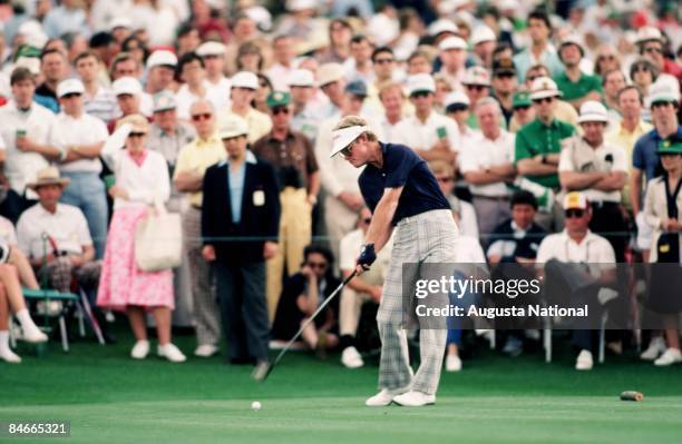Tom Kite blasts off the tee box in front of a large gallery during the 1984 Masters Tournament at Augusta National Golf Club in April 1984 in...