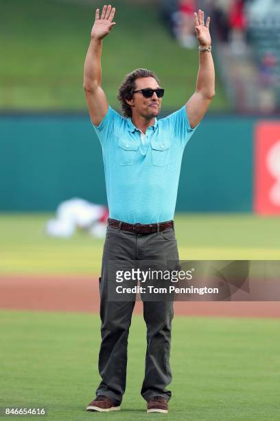 Actor Matthew McConaughey takes part in pregame activities before the Texas Rangers take on the Seattle Mariners at Globe Life Park in Arlington on...
