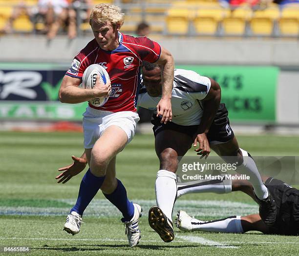 Rikus Pretorius of the USA is tackled by Vereniki Goneva of Fiji during the match between USA and Fiji at Westpac Stadium on day one of the New...