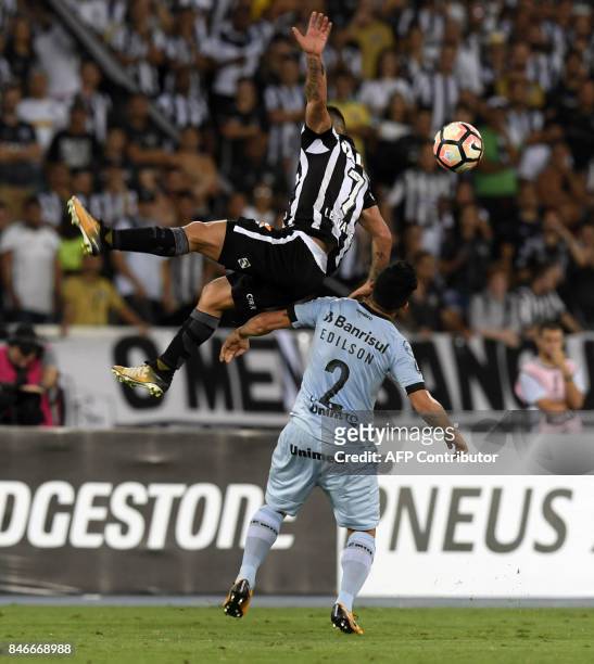 Leo Valencia of Brazil's Botafogo vies for the ball with Edilson of Gremio during their Copa Libertadores 2017 football match at Nilton Santos...