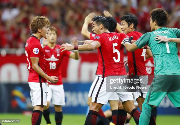 Urawa Reds players celebrate at Saitama Stadium in Saitama, Japan, on Sept. 13, 2017 after erasing a 3-1 first-leg deficit to defeat 10-man Kawasaki...