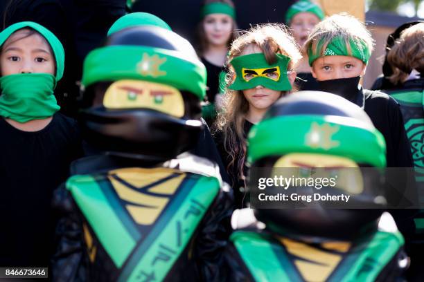 Kids dressed as Lloyd the Green Ninja pose at the Green Ninja Photo Opp With Dave Franco For Warner Bros. Pictures' "The LEGO Ninjago Movie"at...