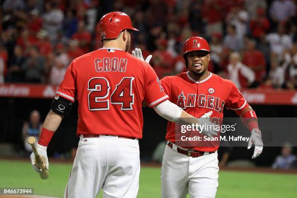 Cron congratulates Luis Valbuena of the Los Angeles Angels of Anaheim after his two-run homerun during the first inning of a game against the Houston...