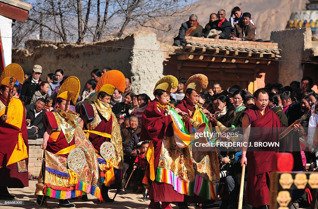 A crowd gathers to watch a procession by