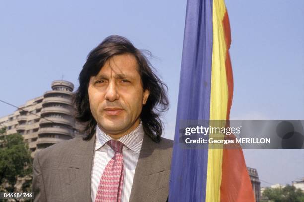 Tennis player Ilie Nastase holding Romanian flag on April 26, 1990 in Bucharest, Romania.