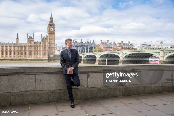 businessman standing on the promenade - leaning back stock pictures, royalty-free photos & images