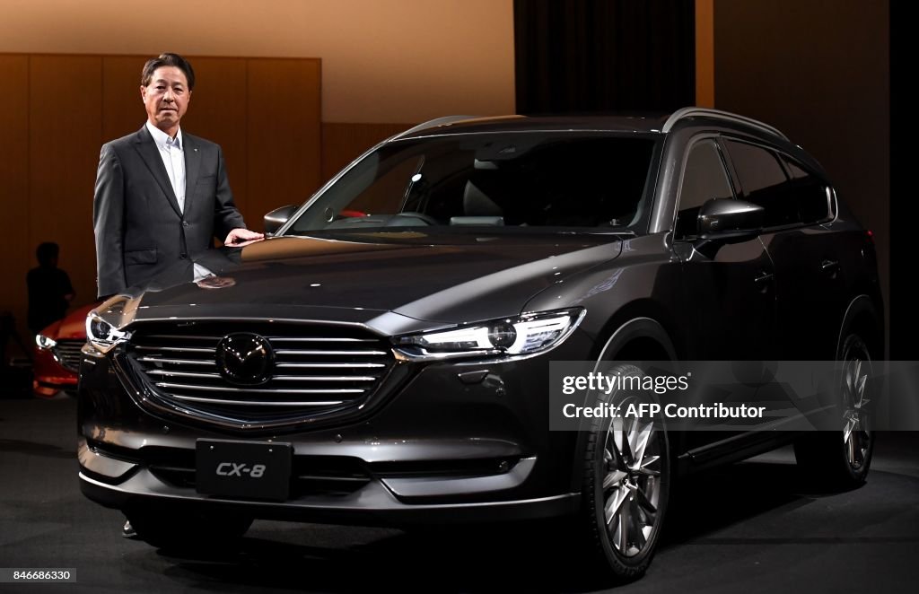 Mazda In Japan Mazda motors president Masamichi Kogai stands beside the company's ...