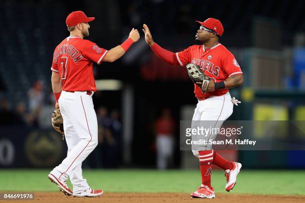 Cliff Pennington and Eric Young Jr. #8 of the Los Angeles Angels of Anaheim celebrate defeating the Houston Astros 9-1 in a game at Angel Stadium of...