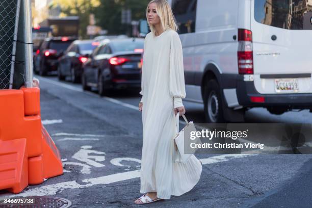 Celine Aagaard wearing white dress seen in the streets of Manhattan outside Michael Kors during New York Fashion Week on September 13, 2017 in New...