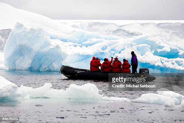 Motoring on the Weddell Sea the tourists come nearer to landing on the ice shelf of Antarctica during a voyage to Antarctica on a ship called "Le...