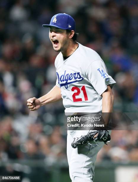 Los Angeles Dodgers pitcher Yu Darvish reacts after getting Buster Posey of the San Francisco Giants to hit into an inning-ending double play in the...