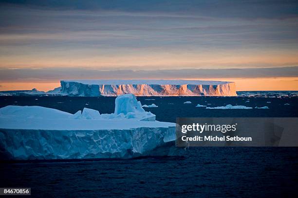 View of the sunset over a tabular iceberg in the Weddell Sea during a voyage to Antarctica on a ship called "Le Diamant" during February 2006.