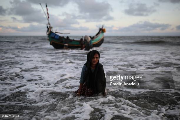 Rohingya Muslim woman, fled from ongoing military operations in Myanmars Rakhine state, gets off a boat while fleeing to a temporary makeshift camp,...