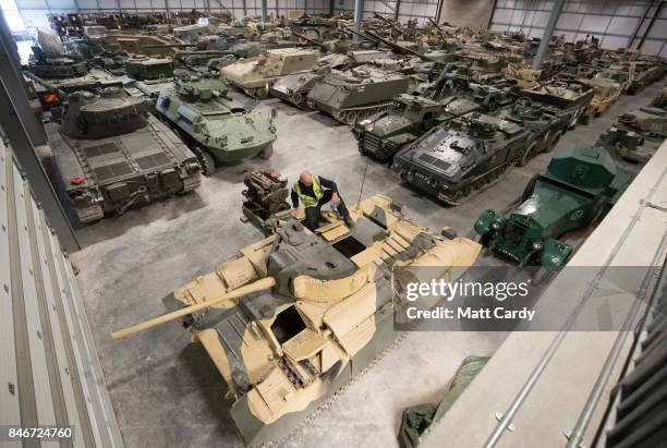 Staff and volunteers help prepare tanks stored at the Vehicle Conservation Centre at the Bovington Tank Museum for this weekend's Tiger Day, which...