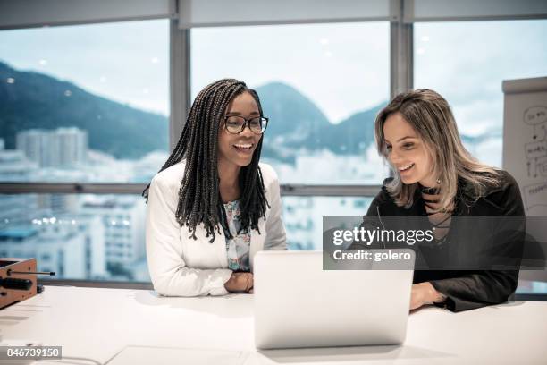 two brazilian businesswoman in office in rio de janeiro - rio de janeiro city stock pictures, royalty-free photos & images