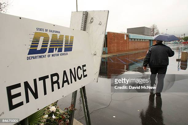 Security guard patrols the empty parking lot of the State of California Department of Motor Vehicles February 6, 2009 in Pasadena, California. The...