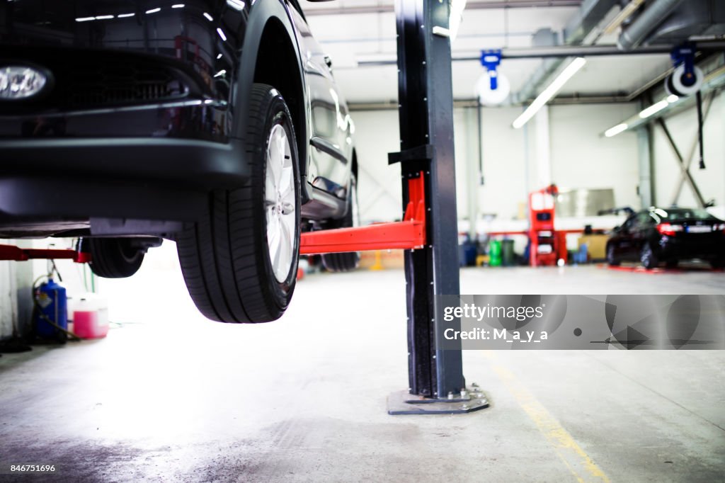 Car on lift at car service