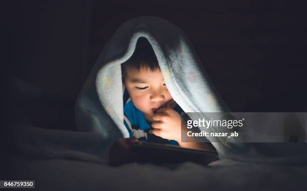 Kid Using Smartphone On Bed.
