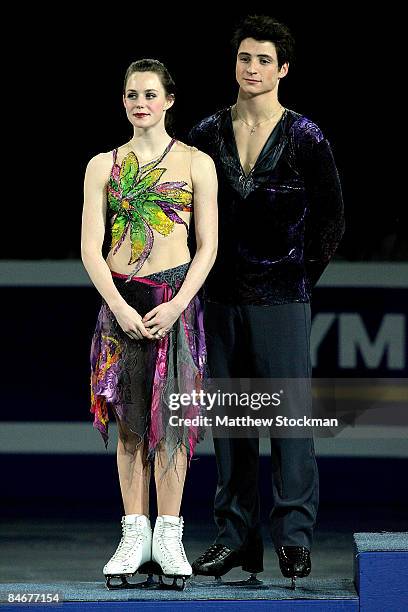 Tessa Virtue and Scott Moir wait for their medals on the winners podium after the Dance Free Skate during the ISU Four Continents Figure Skating...