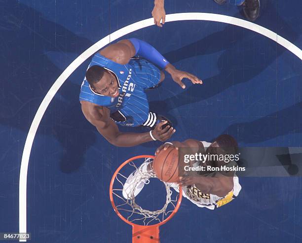 Roy Hibbert of the Indiana Pacers jams over Dwight Howard @12 of the Orlando Magic at Conseco Fieldhouse on February 6, 2009 in Indianapolis,...