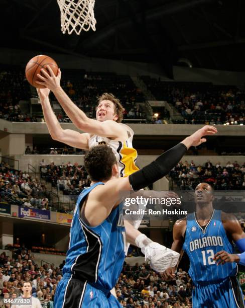 Troy Murphy of the Indiana Pacers shoots over Hedo Turkoglu of the Orlando Magic at Conseco Fieldhouse on February 6, 2009 in Indianapolis, Indiana....