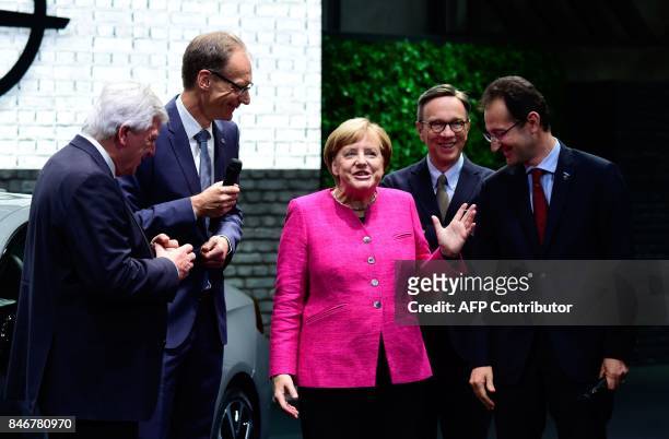 German Chancellor Angela Merkel speaks with Michael Lohscheller , CEO of Opel, Opel's CFO Philippe de Rovira , the president of the German Automobile...